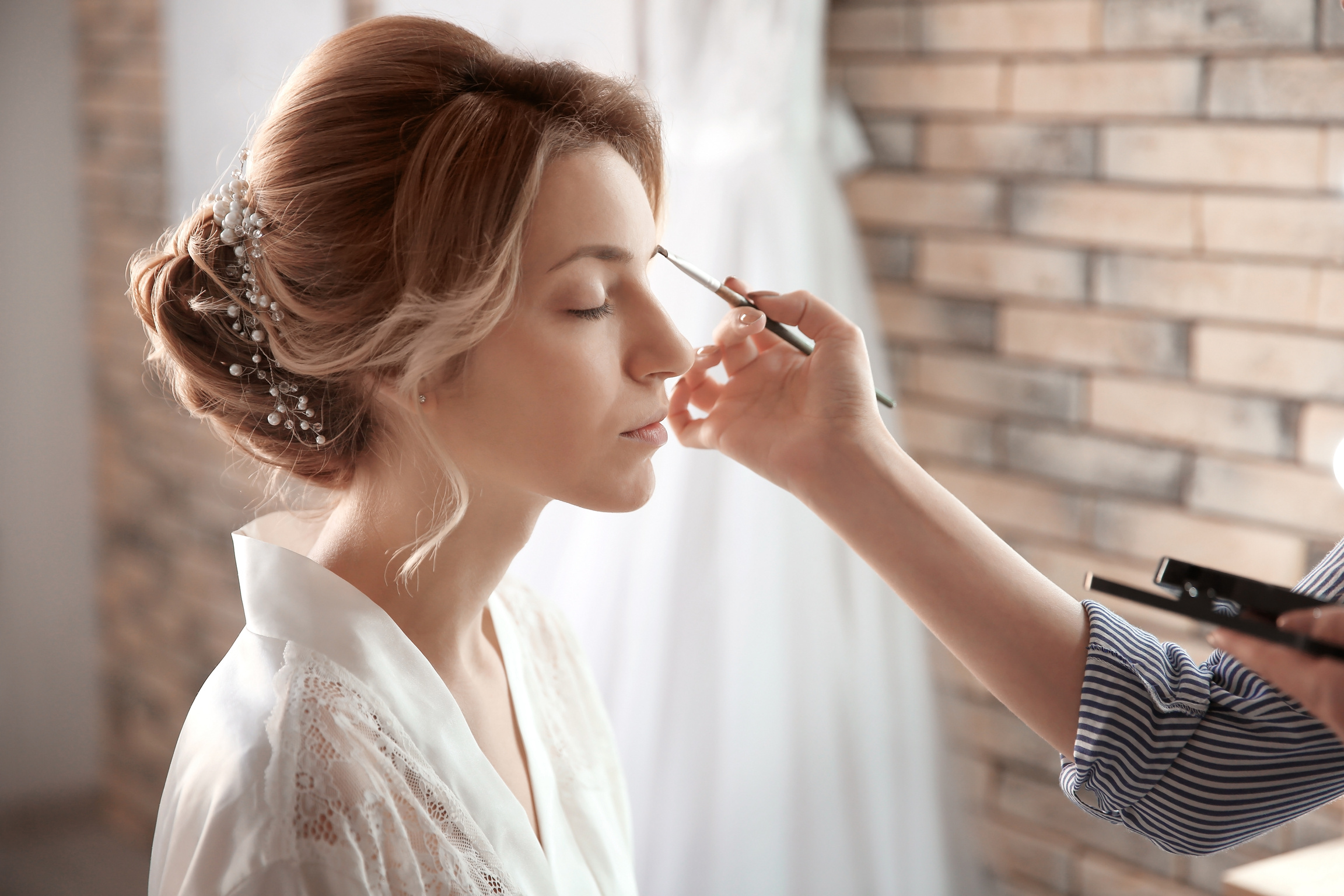 Makeup Artist Preparing Bride in the Room before Her Wedding